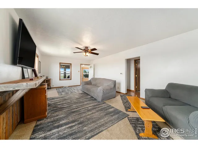 a bedroom with furniture and a flat screen tv