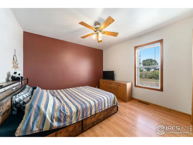 a bedroom with a bed and a desk