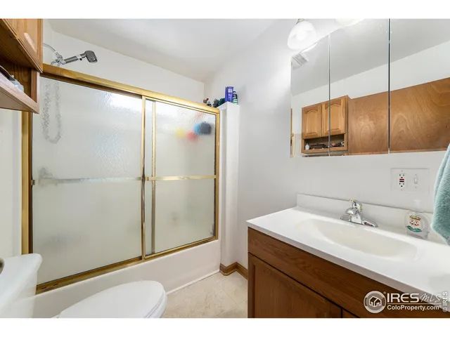 a bathroom with a sink mirror and a shower