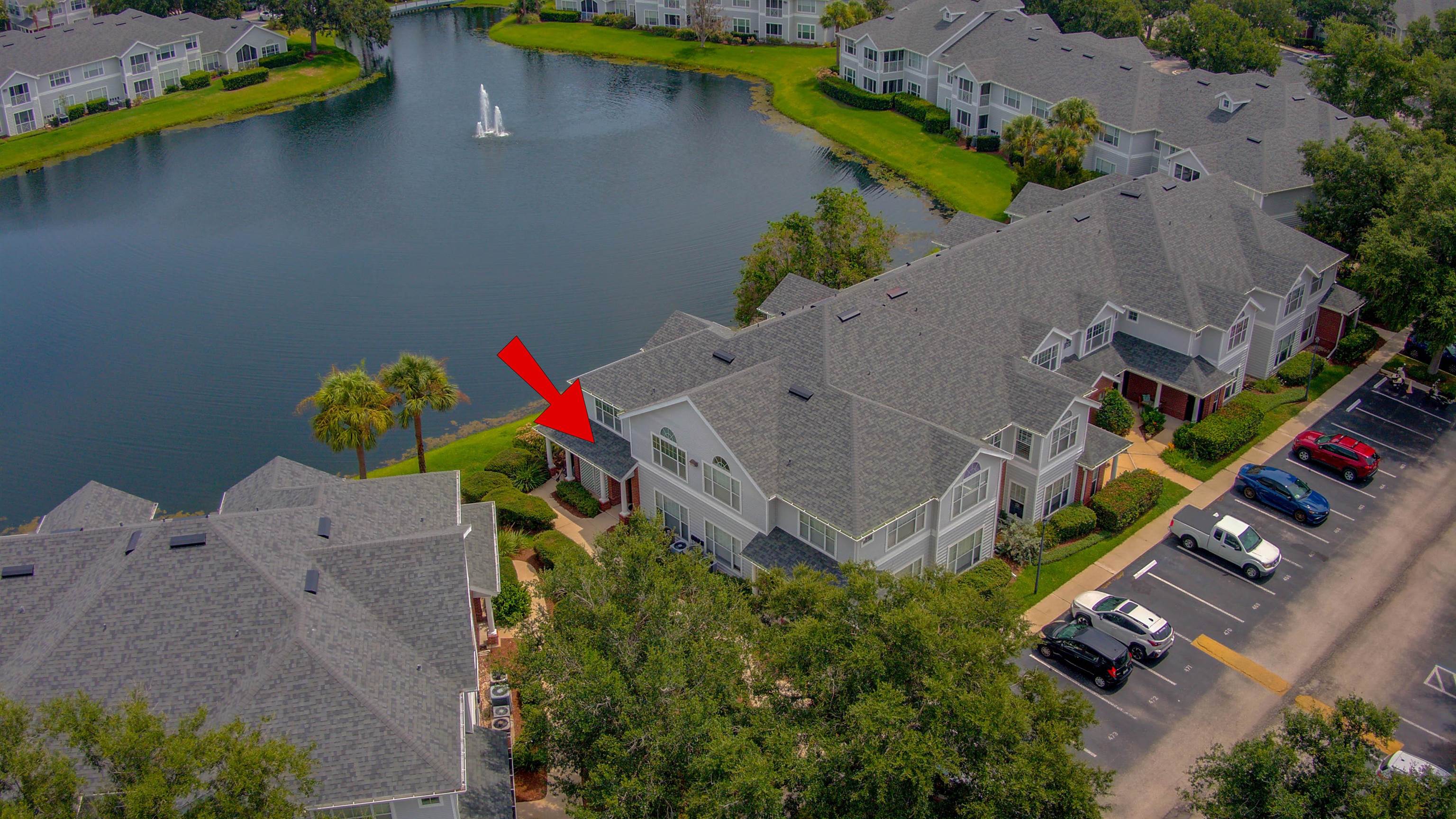 an aerial view of a house with a yard and a swimming pool