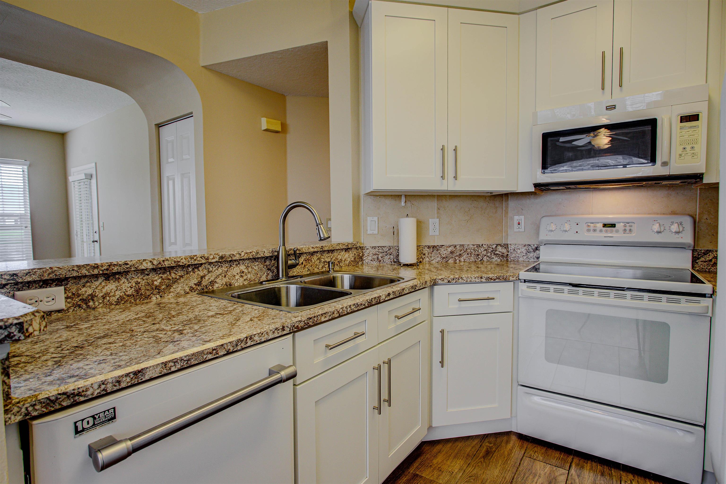 20102 Harbour Vista Circle St. Augustine, FL 32080 - Photo 17 of 31 a kitchen with white cabinets appliances and a sink