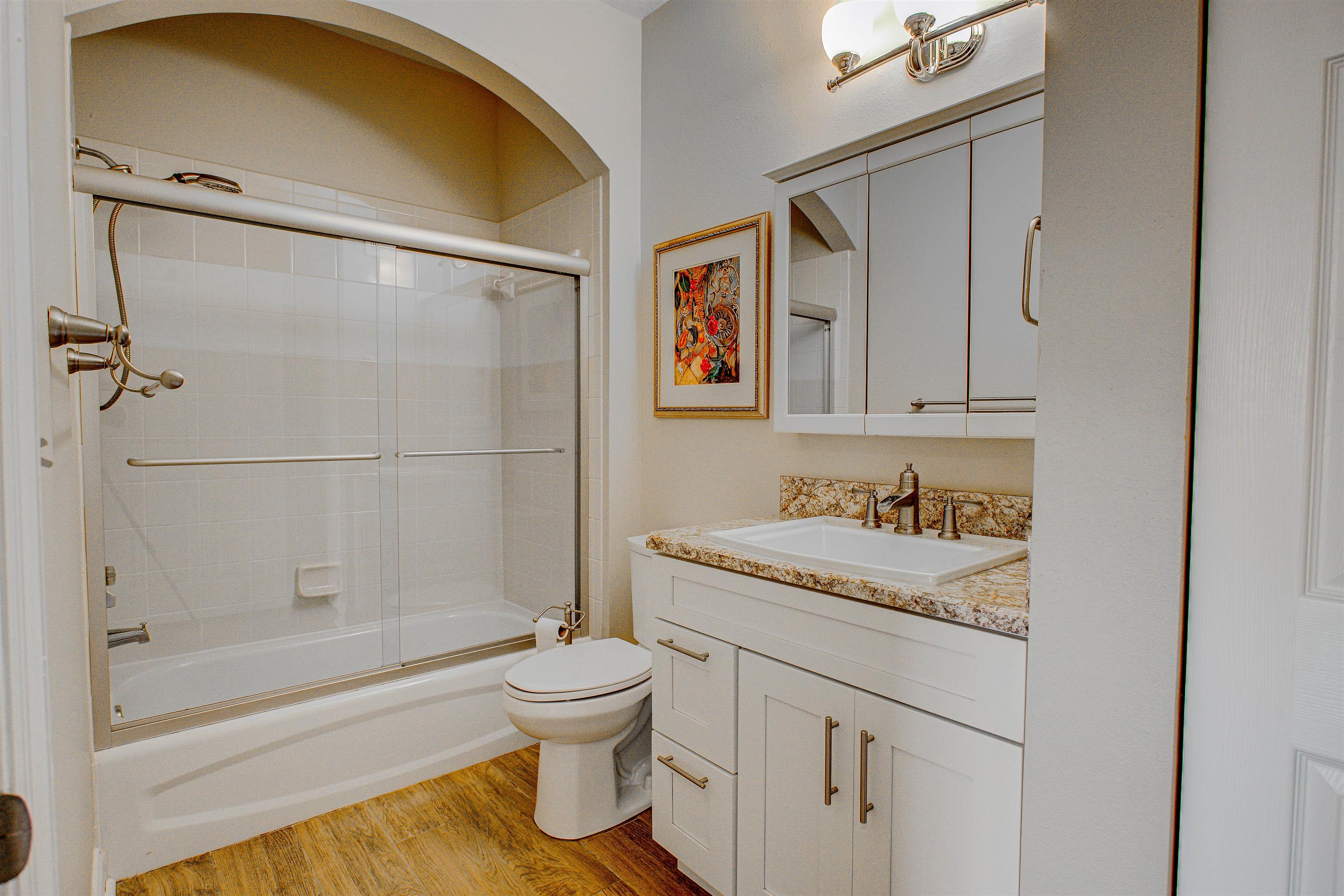 20102 Harbour Vista Circle St. Augustine, FL 32080 - Photo 19 of 31 a bathroom with a granite countertop sink toilet and shower