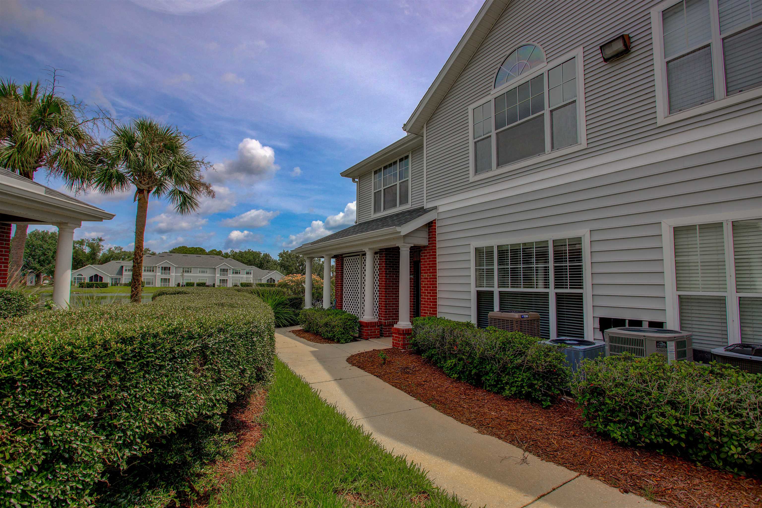 20102 Harbour Vista Circle St. Augustine, FL 32080 - Photo 2 of 31 a front view of a house with a yard and potted plants