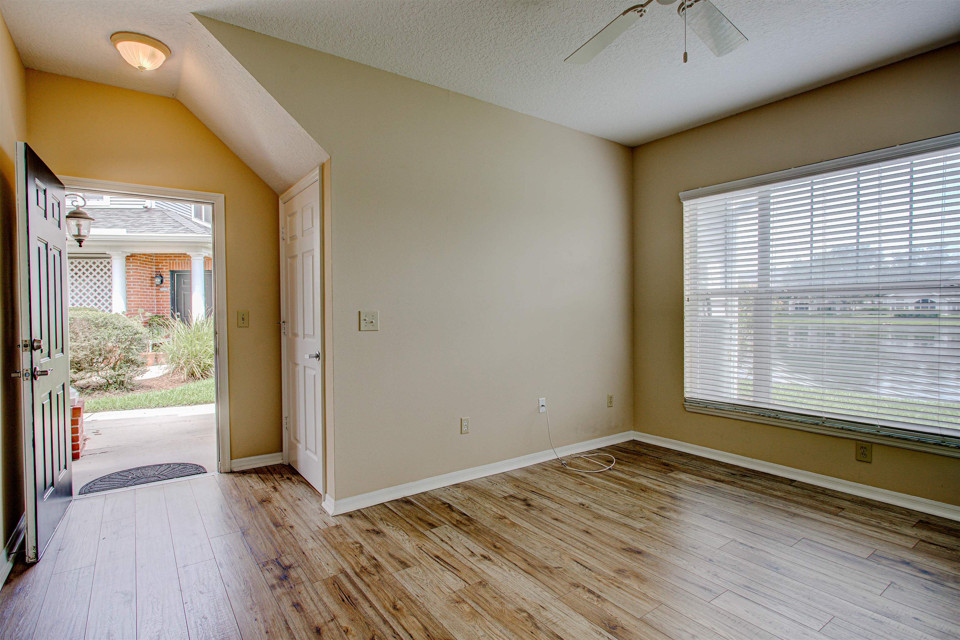 20102 Harbour Vista Circle St. Augustine, FL 32080 - Photo 6 of 31 an empty room with wooden floor and windows