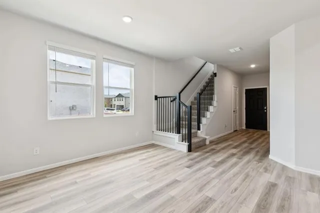 a view of entryway with wooden floor and stairs