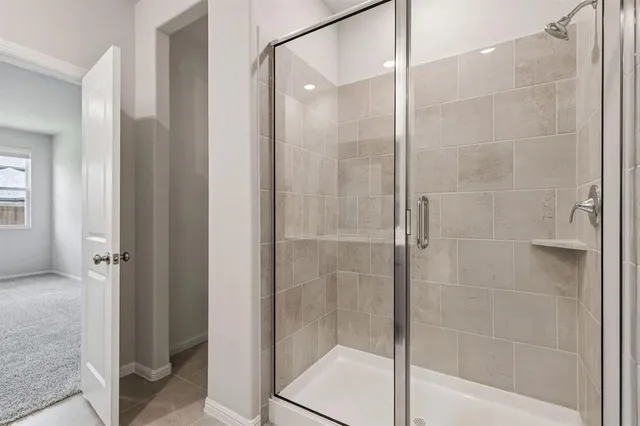 a bathroom with a glass shower door