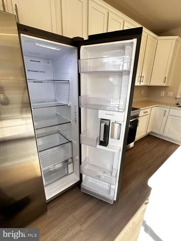 a kitchen with white cabinets and appliances