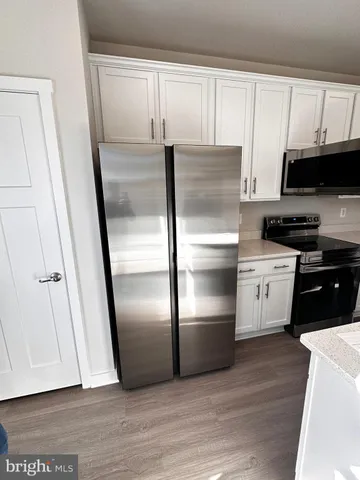 a kitchen with a wooden floor and a stove