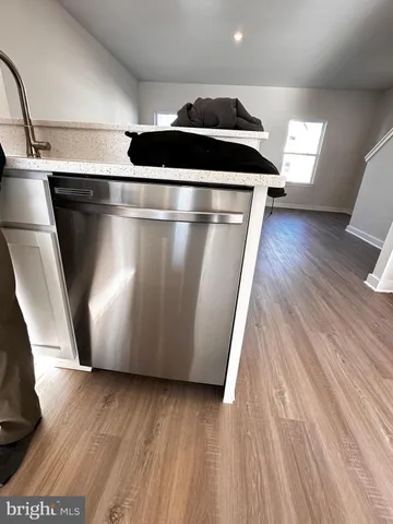 an empty room with wooden floor and mirror