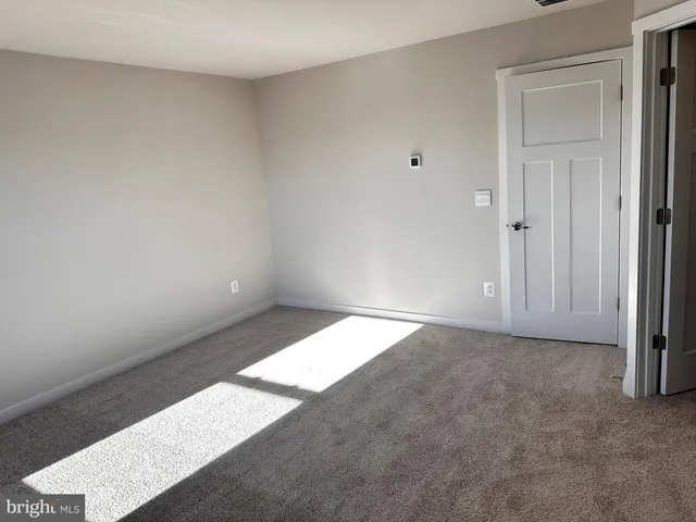 a view of a hallway with paintings on the wall