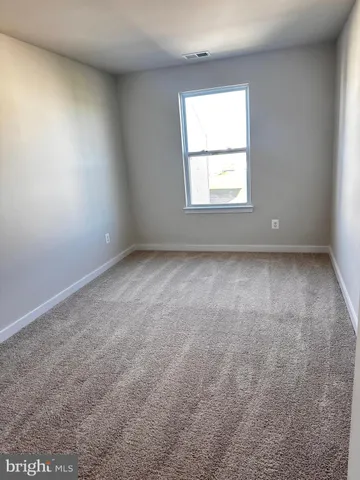 an empty room with closet area