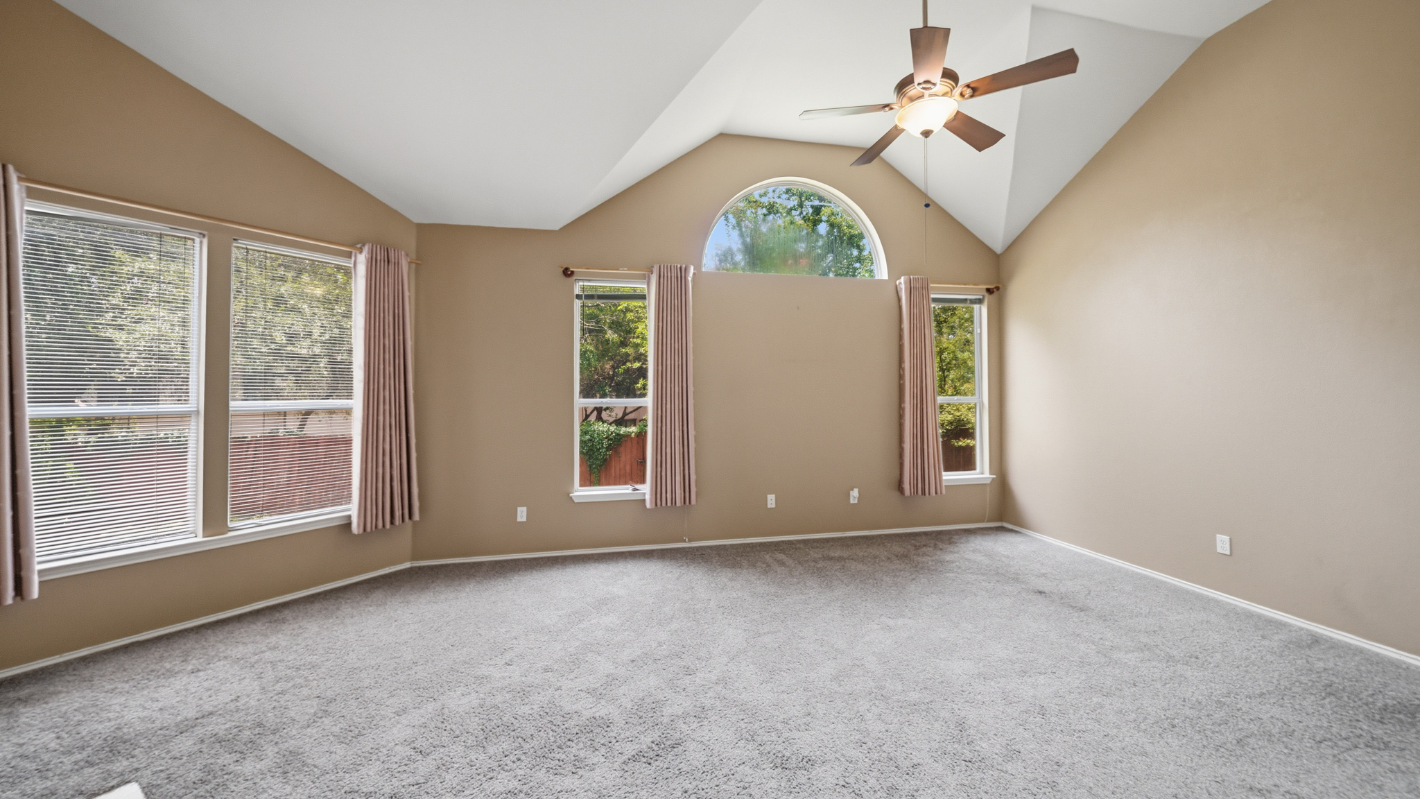 1108 Antelope Ridge Cedar Park, TX 78613 - Photo 11 of 27 Vast vaulted ceilings complement an arched window, adding architectural interest to this ample room.