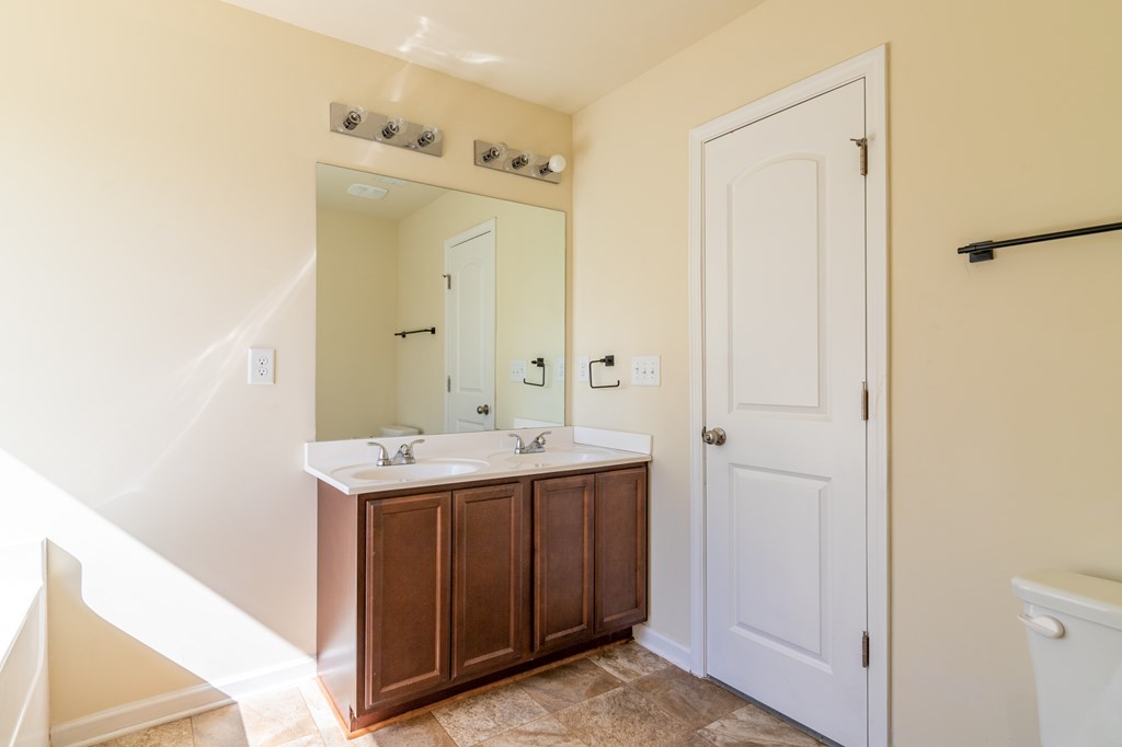 304 Irish Court Phenix City, AL 36869 - Photo 12 of 20 a bathroom with a sink a mirror and a shower