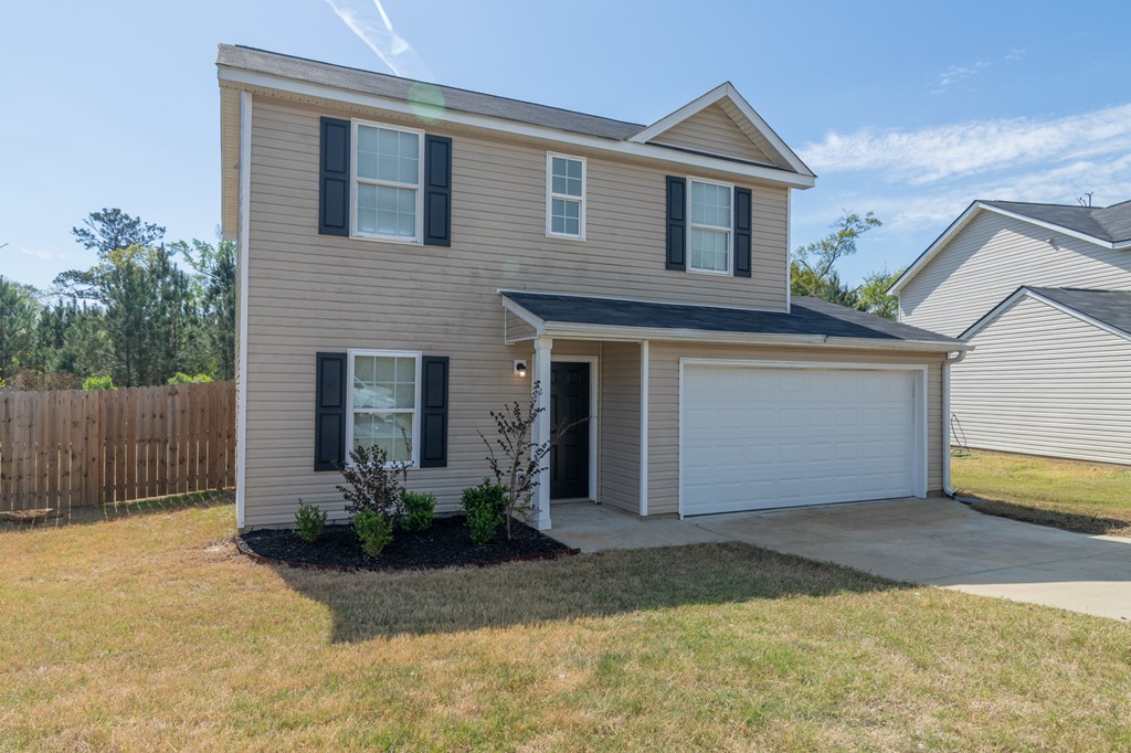 304 Irish Court Phenix City, AL 36869 - Photo 2 of 20 a front view of house with garage and yard
