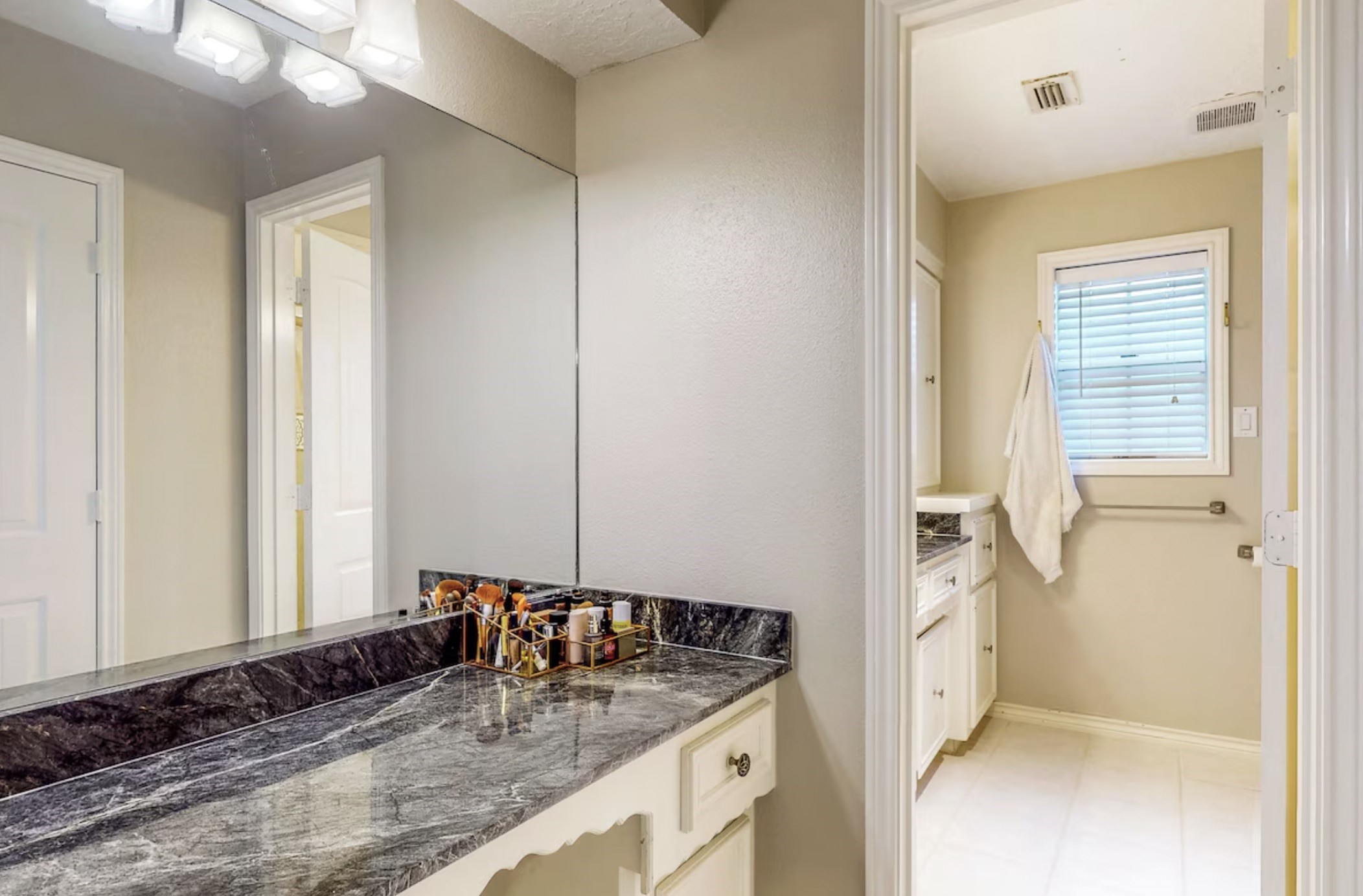 30819 Quinn Road Tomball, TX 77375 - Photo 14 of 30 a bathroom with a granite countertop sink and a mirror