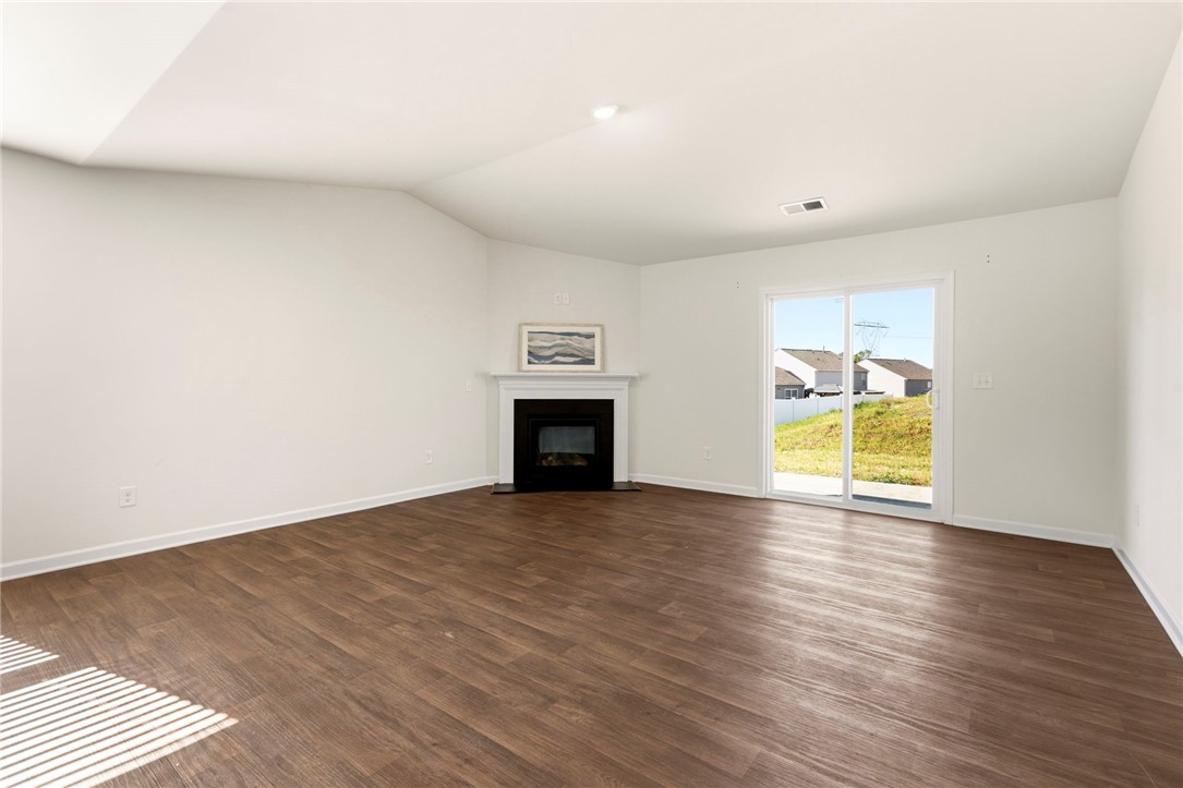 205 Hillendale Way Pelzer, SC 29669 - Photo 5 of 29 This living room features a fireplace and direct outdoor access, perfect for relaxation and gatherings.