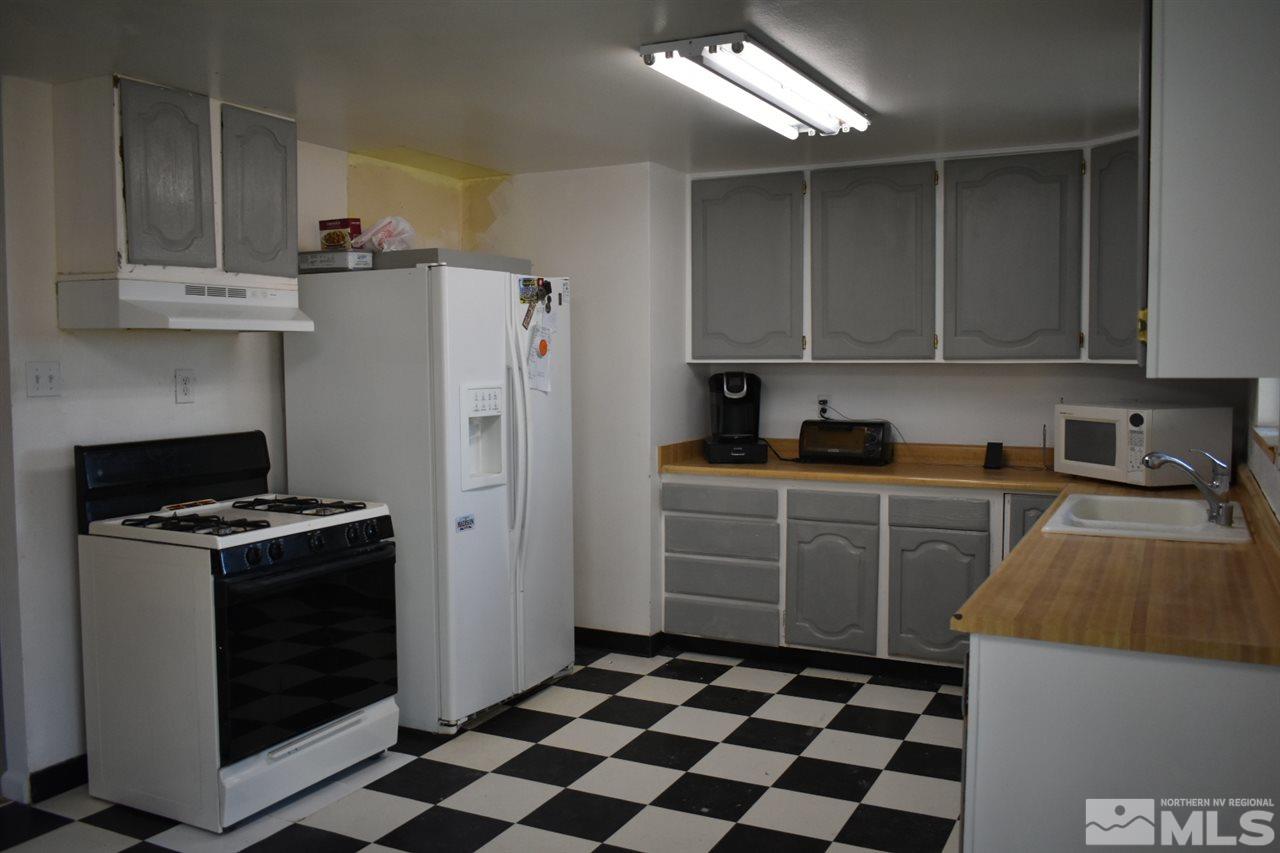 9355 Pagoda Way Reno, NV 89506 - Photo 7 of 18 a kitchen with a stove a refrigerator and cabinets