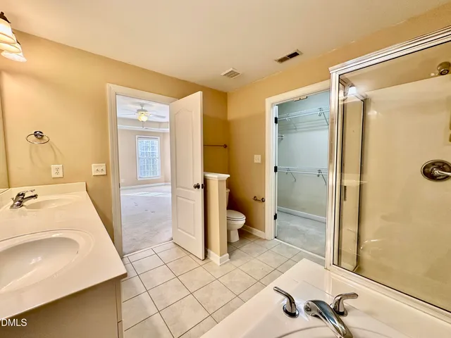 a spacious bathroom with a sink and mirror