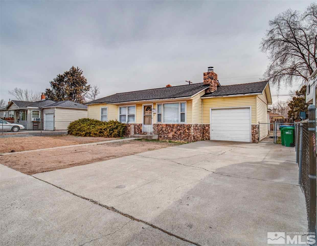 940 Wilkinson Avenue Reno, NV 89502 - Photo 1 of 29 a front view of a house with a yard and garage