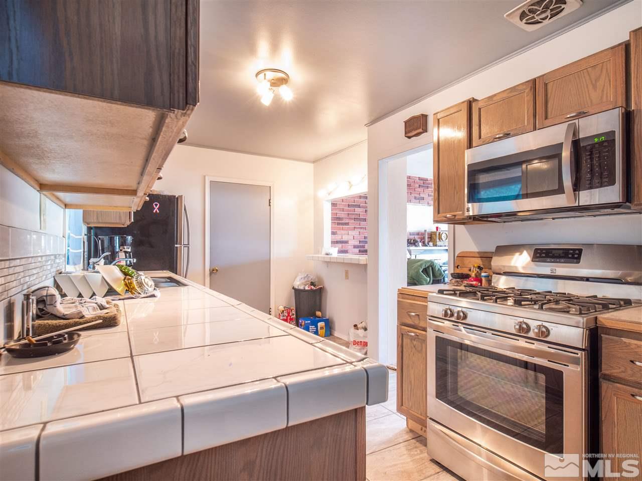 940 Wilkinson Avenue Reno, NV 89502 - Photo 12 of 29 a kitchen with a stove and a microwave