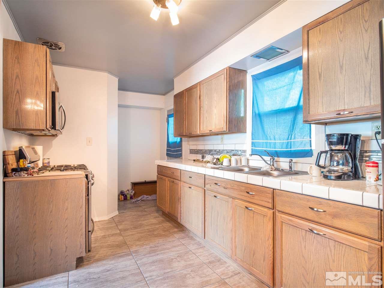 940 Wilkinson Avenue Reno, NV 89502 - Photo 13 of 29 a kitchen with cabinets and window