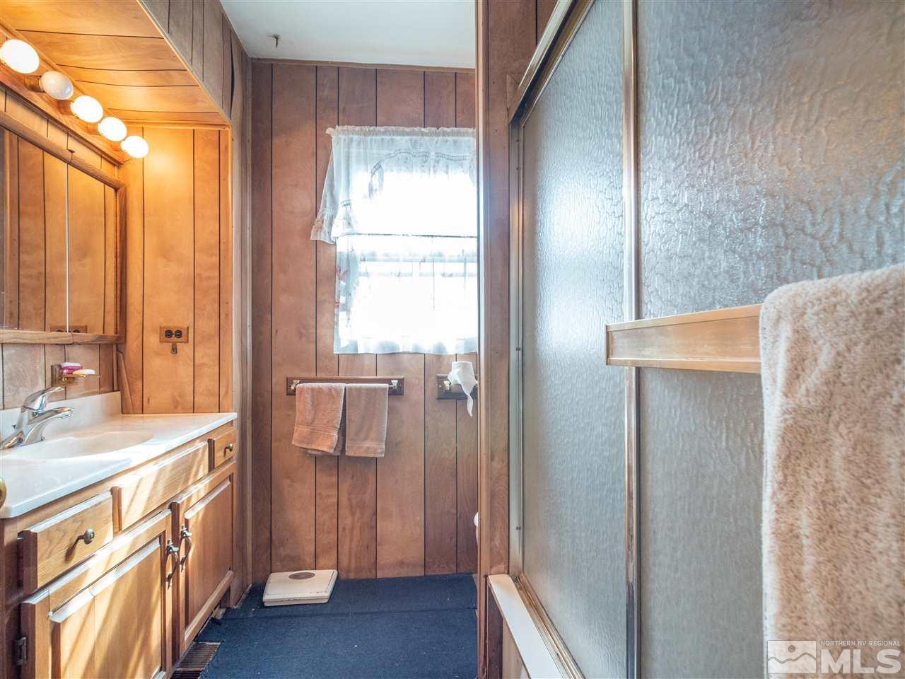 940 Wilkinson Avenue Reno, NV 89502 - Photo 17 of 29 a bathroom with a sink a mirror and a shower