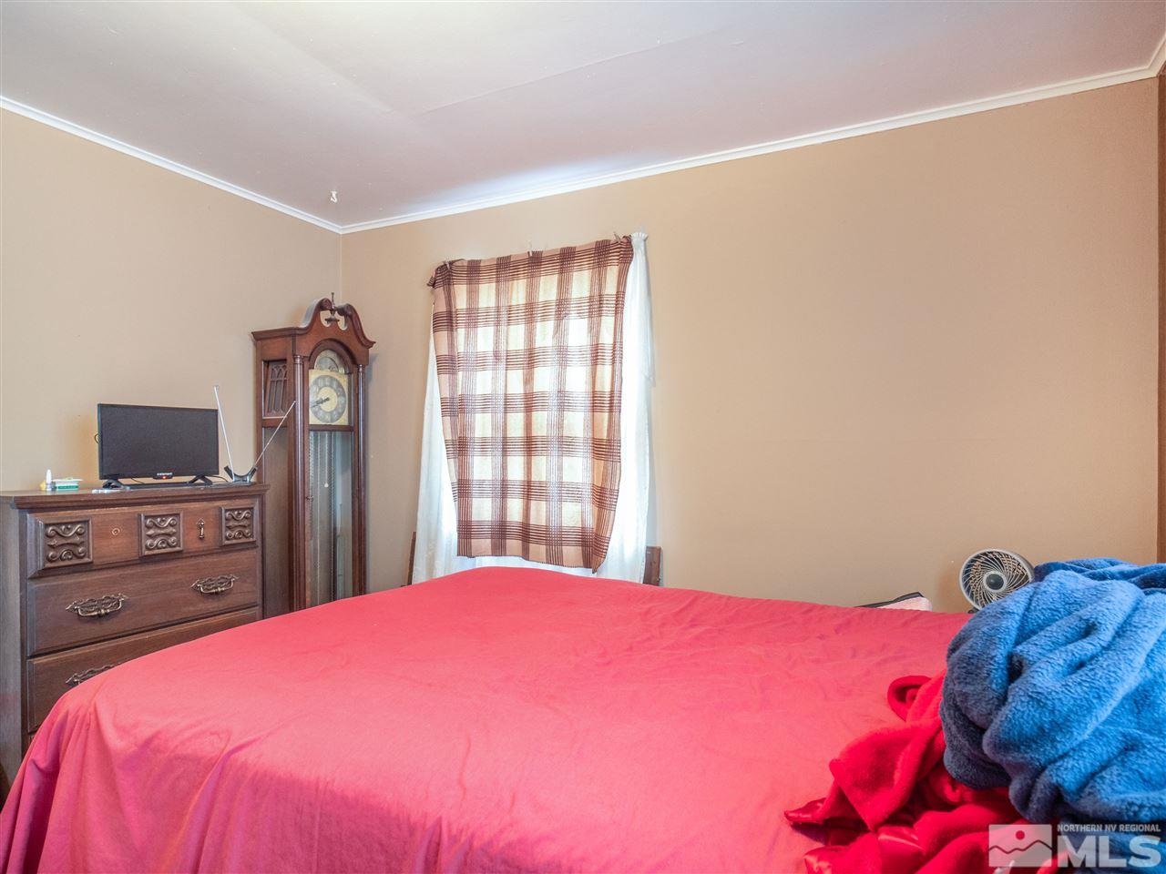 940 Wilkinson Avenue Reno, NV 89502 - Photo 21 of 29 a bedroom with a bed and a flat screen tv