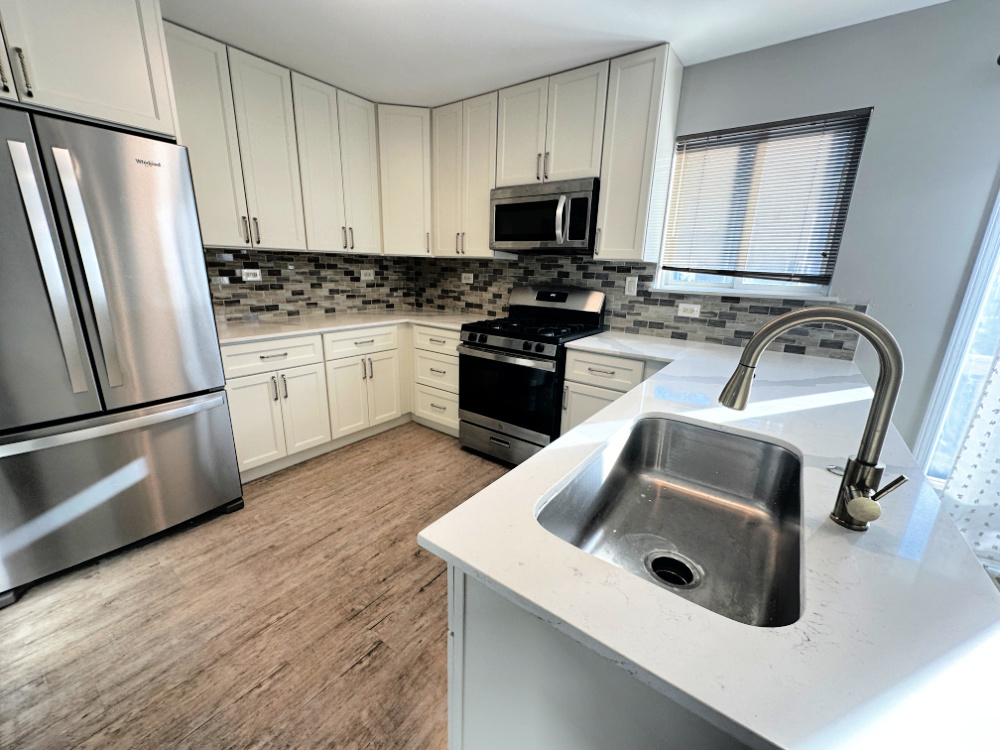 924 Clover Lane, Unit 1 Pingree Grove, IL 60140 - Photo 2 of 15 a kitchen with sink a microwave a stove and refrigerator