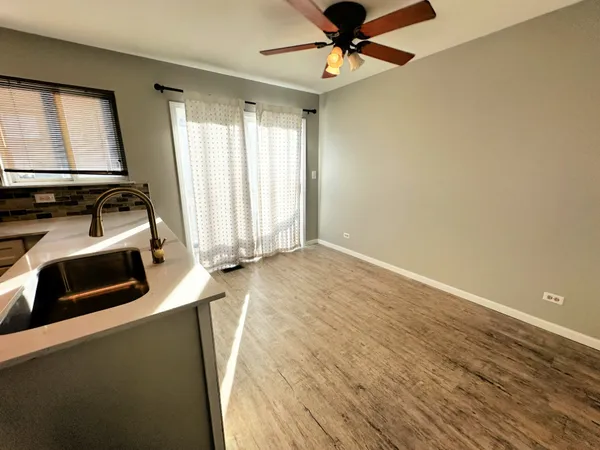 wooden floor chandelier and window in a room