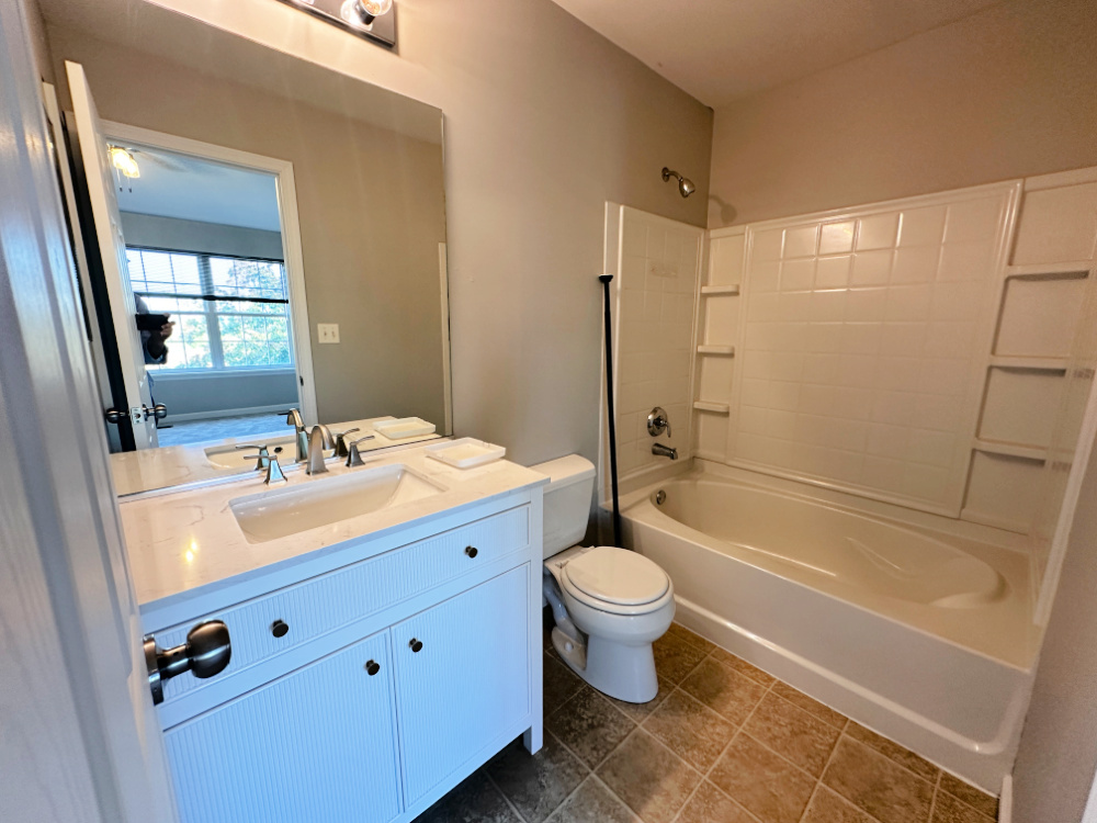 924 Clover Lane, Unit 1 Pingree Grove, IL 60140 - Photo 8 of 15 a bathroom with a double vanity sink a mirror a bathtub and shower