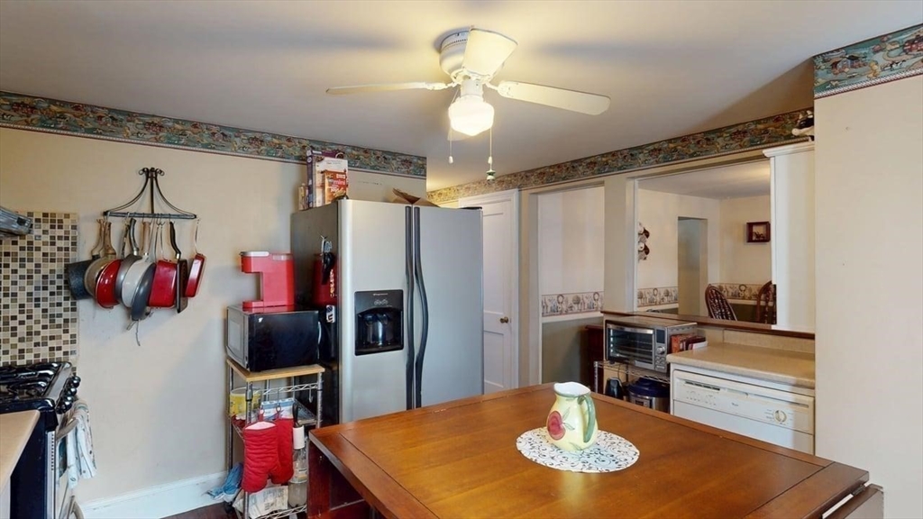 14 Jones Avenue Pawtucket, RI 02861 - Photo 15 of 32 a kitchen with stainless steel appliances granite countertop a dining table and chairs