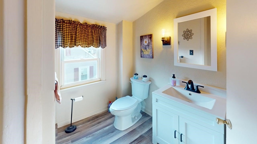 14 Jones Avenue Pawtucket, RI 02861 - Photo 29 of 32 a bathroom with a toilet a sink and mirror
