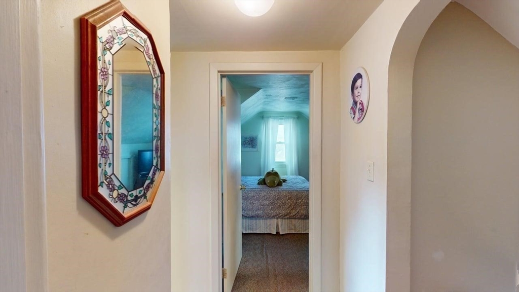14 Jones Avenue Pawtucket, RI 02861 - Photo 6 of 32 a view of a hallway with wooden floor and a bathroom