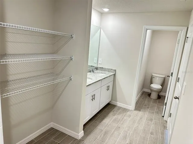 a bathroom with a sink a toilet and a mirror
