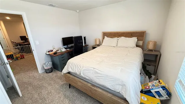 a bedroom with a bed and a mirror