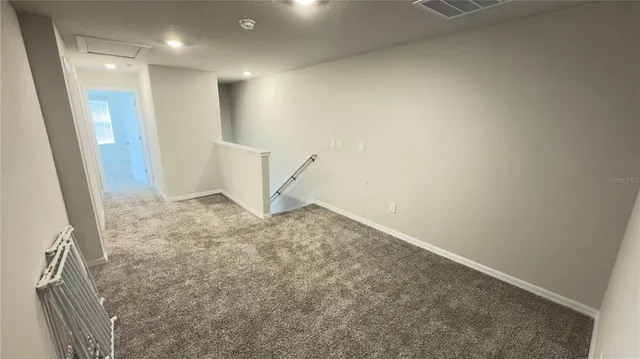an empty room with an entrance to other room