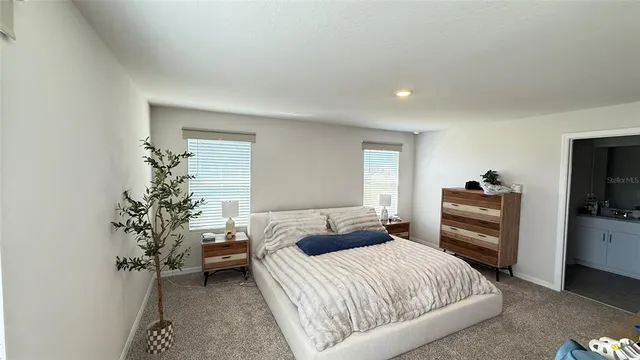 a bedroom with a bed and a television