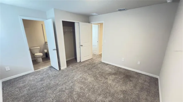 a view of room with a hallway and toilet