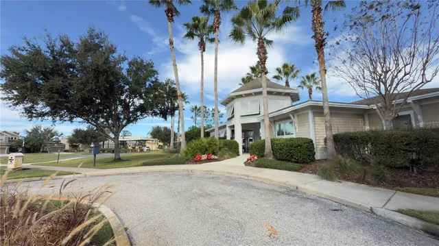a view of a building with a yard and plants
