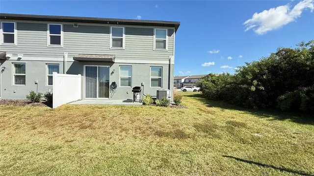 a view of a house with backyard and sitting area