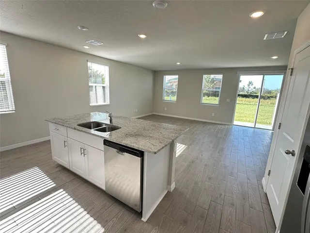 a view of kitchen with stove and wooden floor
