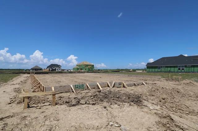 a view of a lake with houses in the back