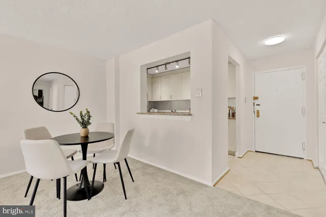 a dining room with furniture and a mirror