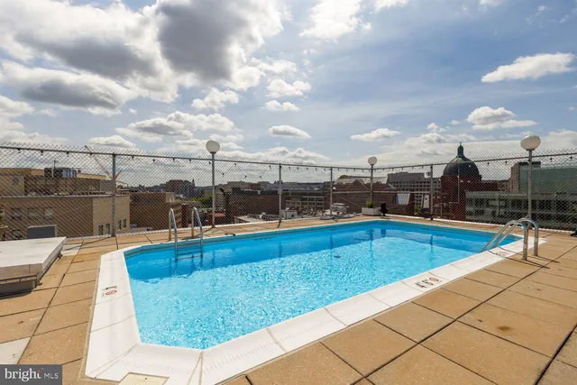 a view of a swimming pool with a lounge chair