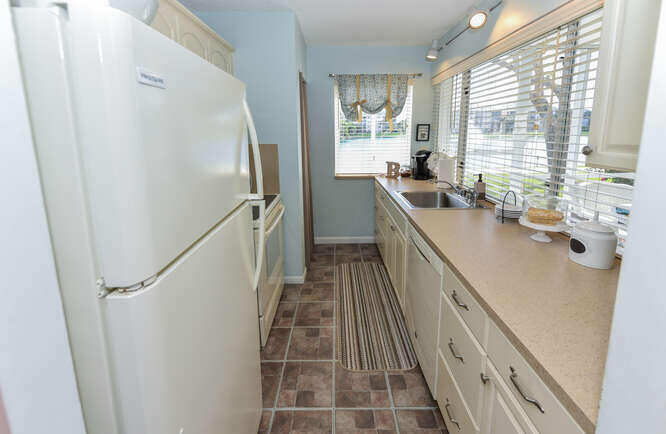 353 Highway 1, Unit A108 Jupiter, FL 33477 - Photo 17 of 36 a kitchen with sink a window and stainless steel appliances