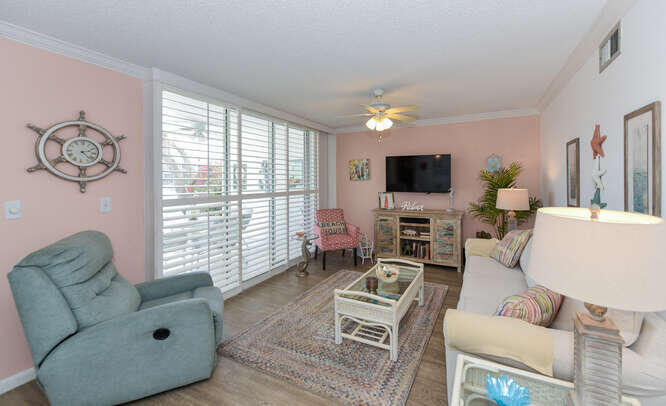 353 Highway 1, Unit A108 Jupiter, FL 33477 - Photo 4 of 36 a living room with furniture a flat screen tv and a window
