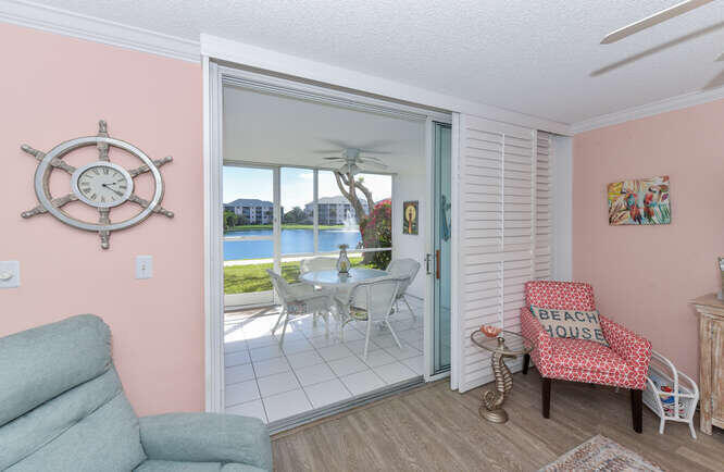 353 Highway 1, Unit A108 Jupiter, FL 33477 - Photo 6 of 36 a living room with furniture a table and a large window