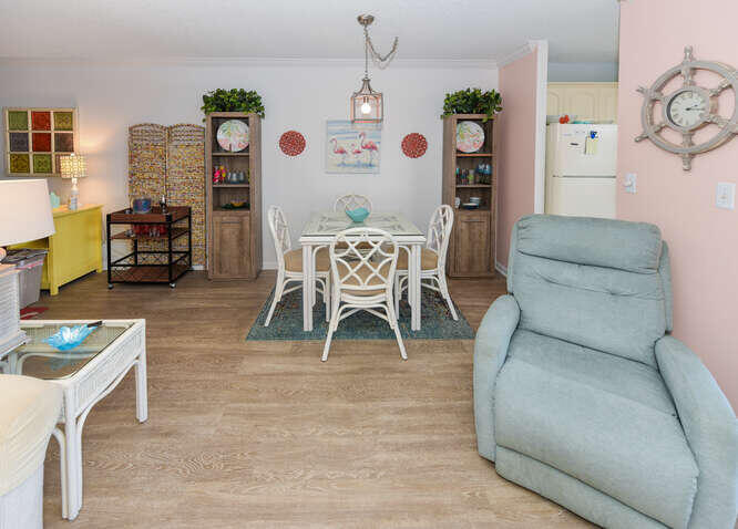 353 Highway 1, Unit A108 Jupiter, FL 33477 - Photo 9 of 36 a living room with furniture a dining table and a fireplace with wooden floor