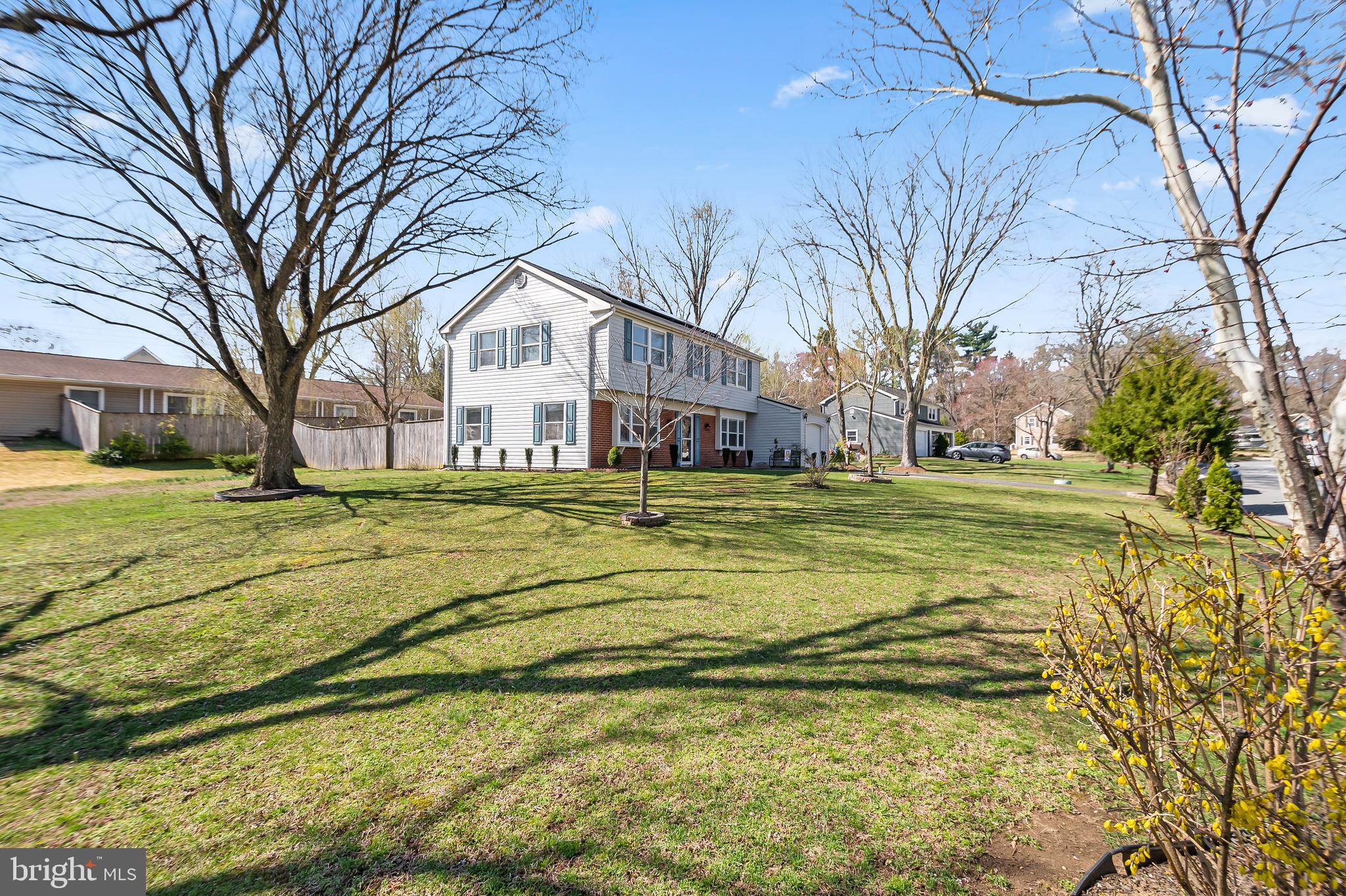 12613 Knowledge Lane Bowie, MD 20715 - Photo 4 of 32 a view of a house with a big yard and large trees