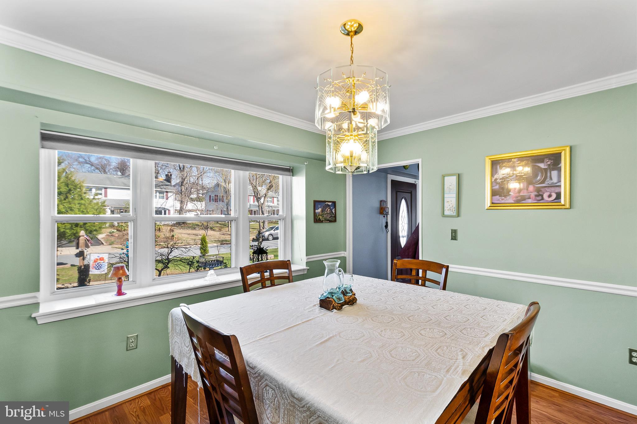 12613 Knowledge Lane Bowie, MD 20715 - Photo 10 of 32 a view of a dining room with furniture a chandelier and window